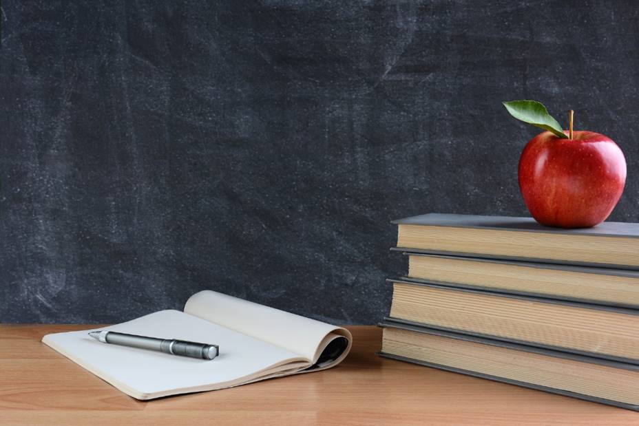 An apple sitting on top of a wooden table

Description automatically generated